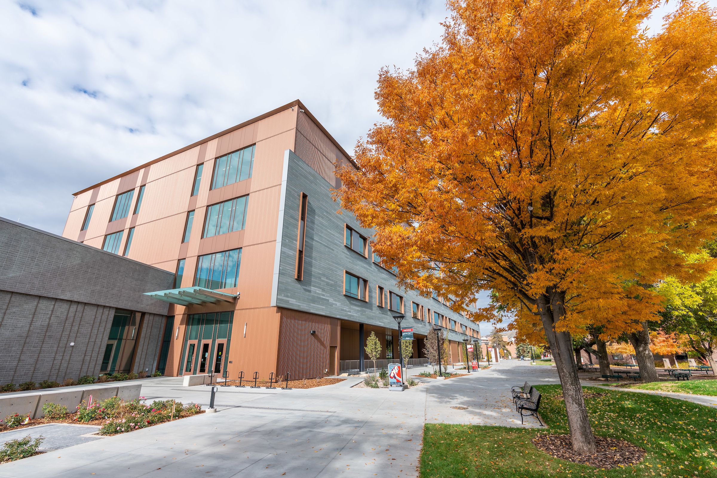 exterior of the Gardner Commons building at the University of Utah surrounded by trees with autumn foliage